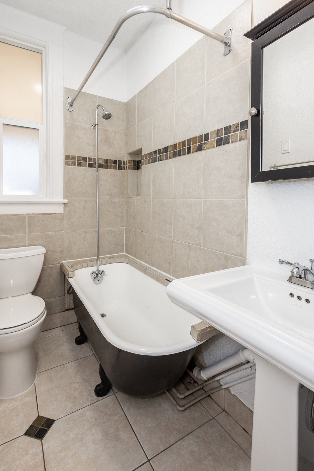 a bathroom with a tub and a sink and a toilet