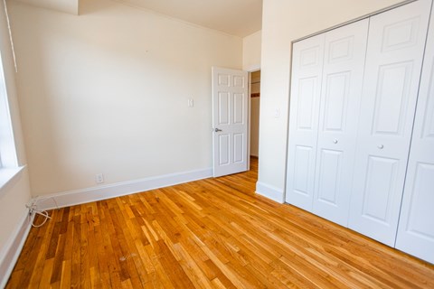 A room with wooden floors and white walls.