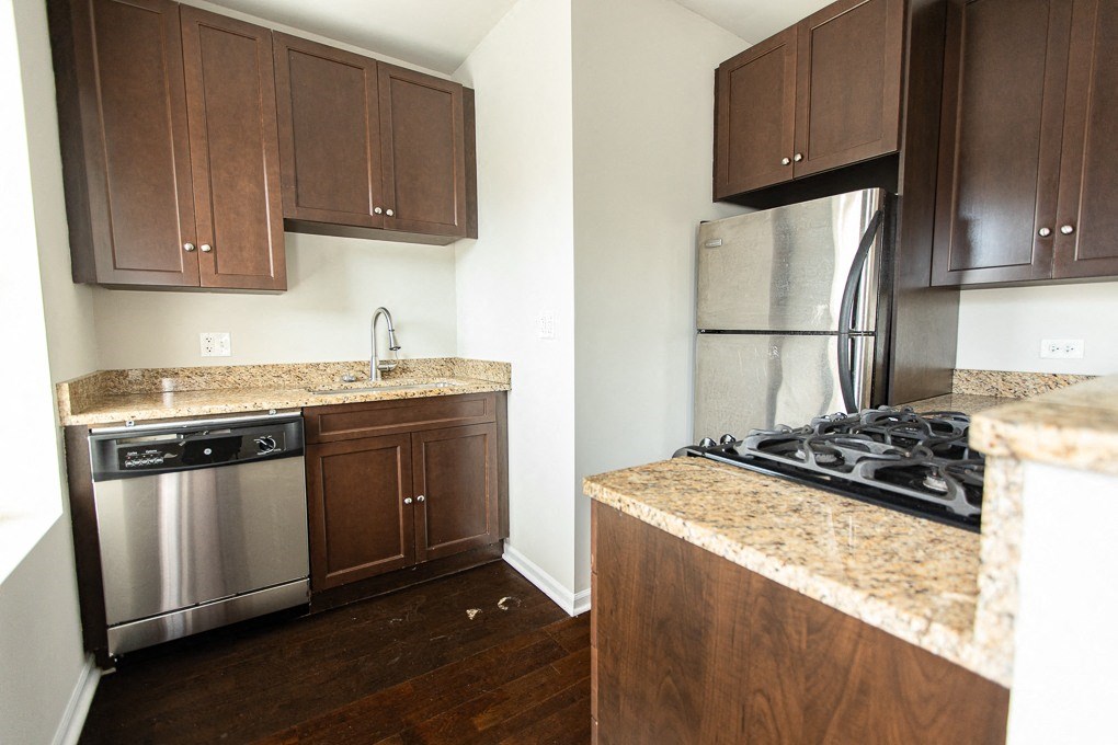 a kitchen with stainless steel appliances and granite counter tops