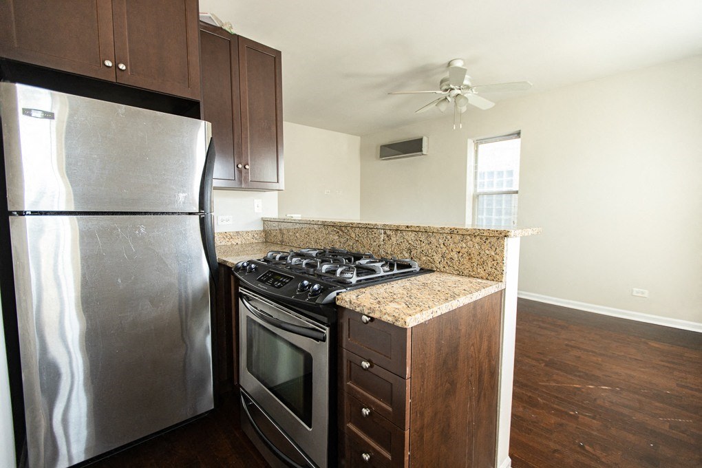 a kitchen with stainless steel appliances and a granite counter top