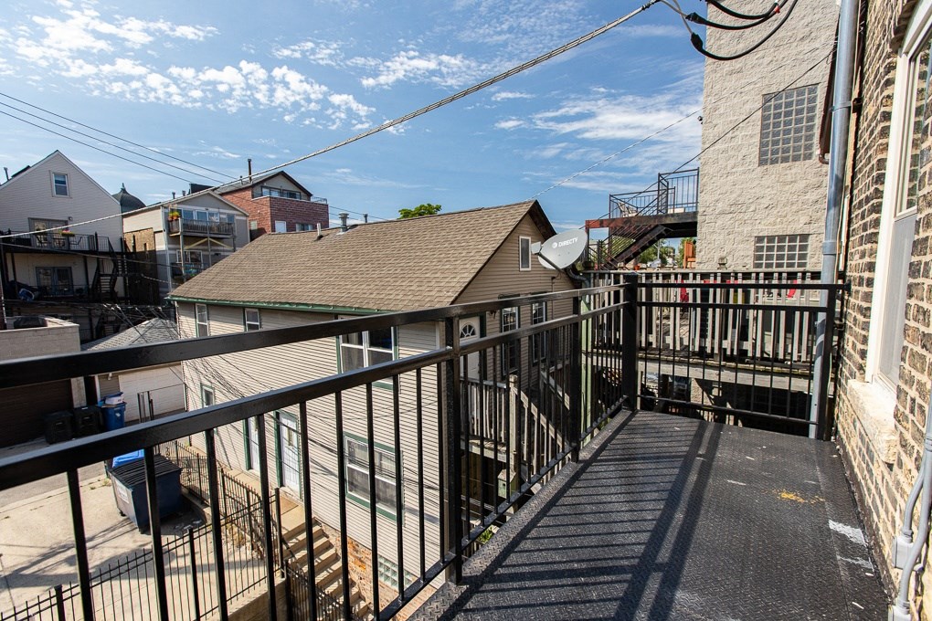 a view from the balcony of a house with a yard and a balcony railings