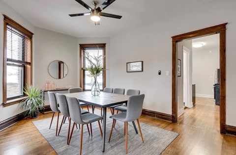 A dining room with a table and chairs.