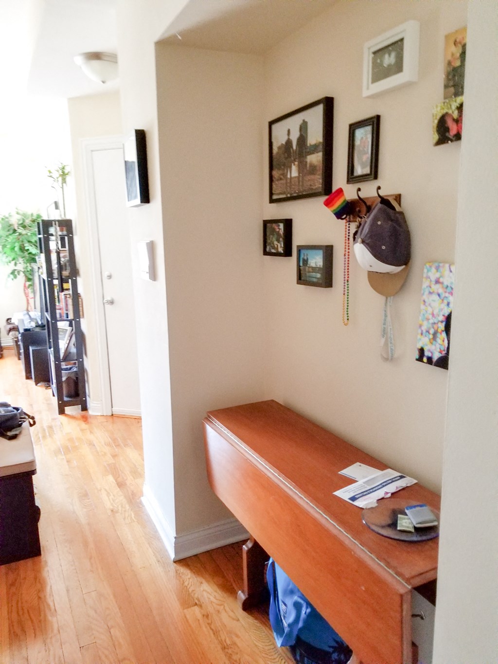 a room with a desk and a hat hanging on the wall