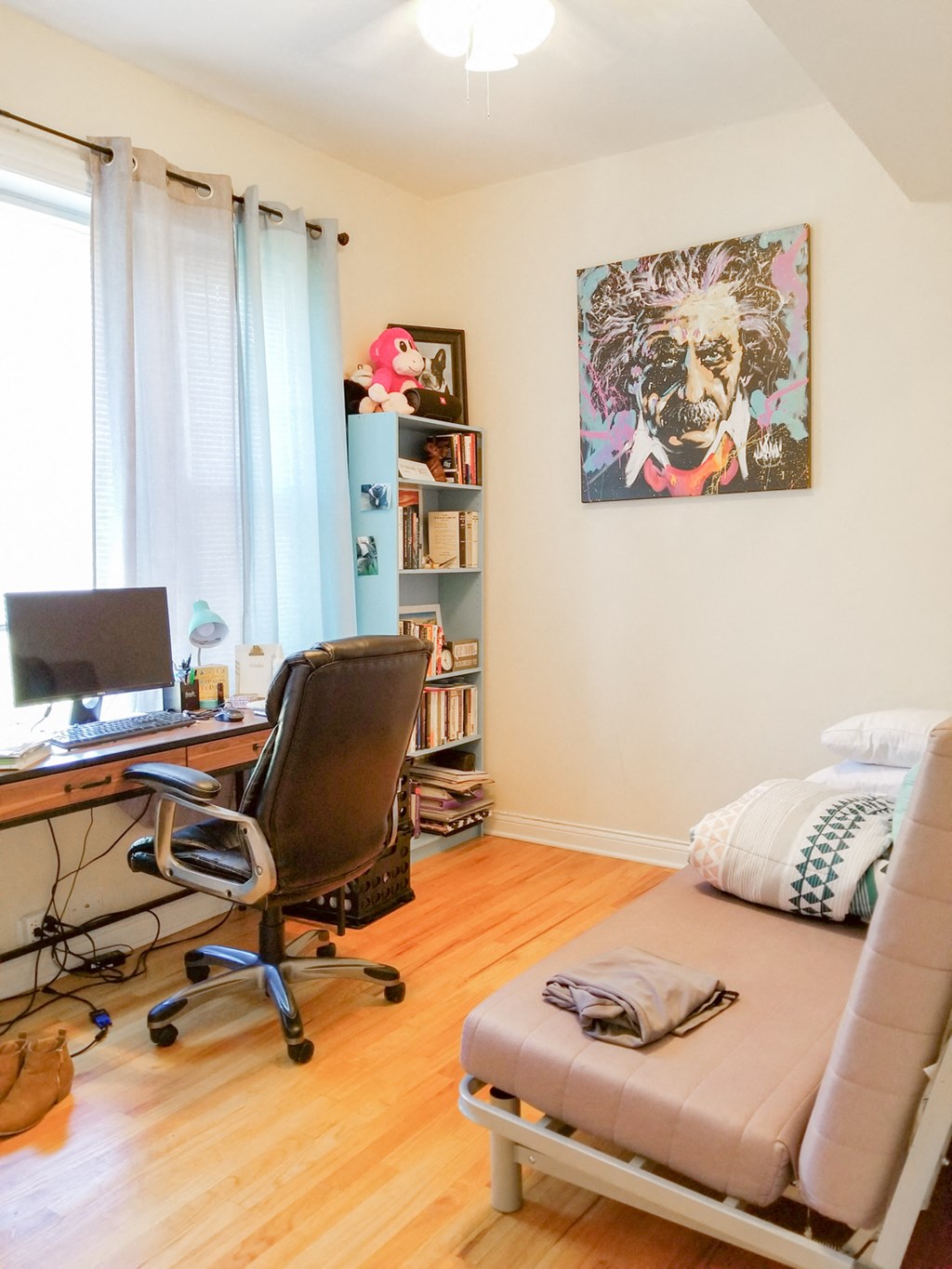 a bedroom with a desk and a futon     and a chair