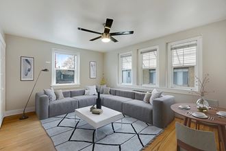 a living room with a couch and a ceiling fan