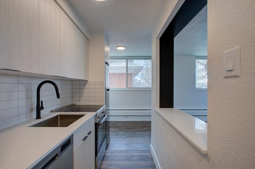 an empty kitchen with a sink and a window