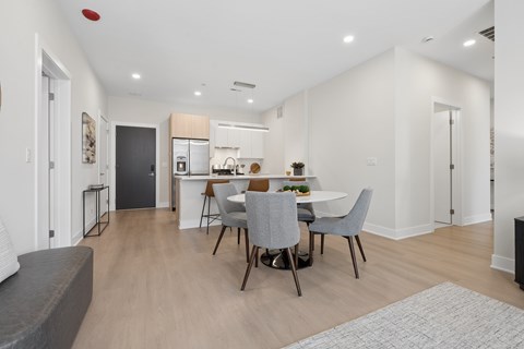 A modern kitchen with a dining table and chairs.
