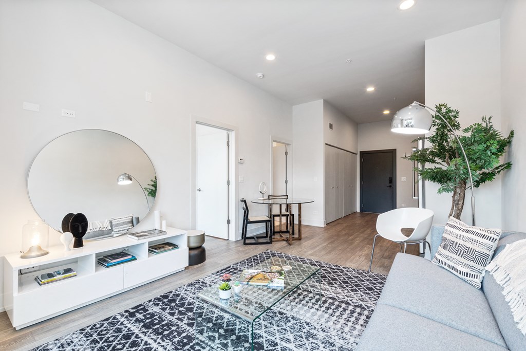 A living area with white walls and hardwood floors