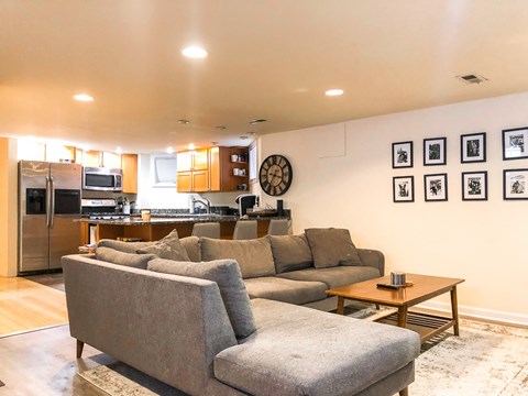 A living room with a grey couch and a coffee table.