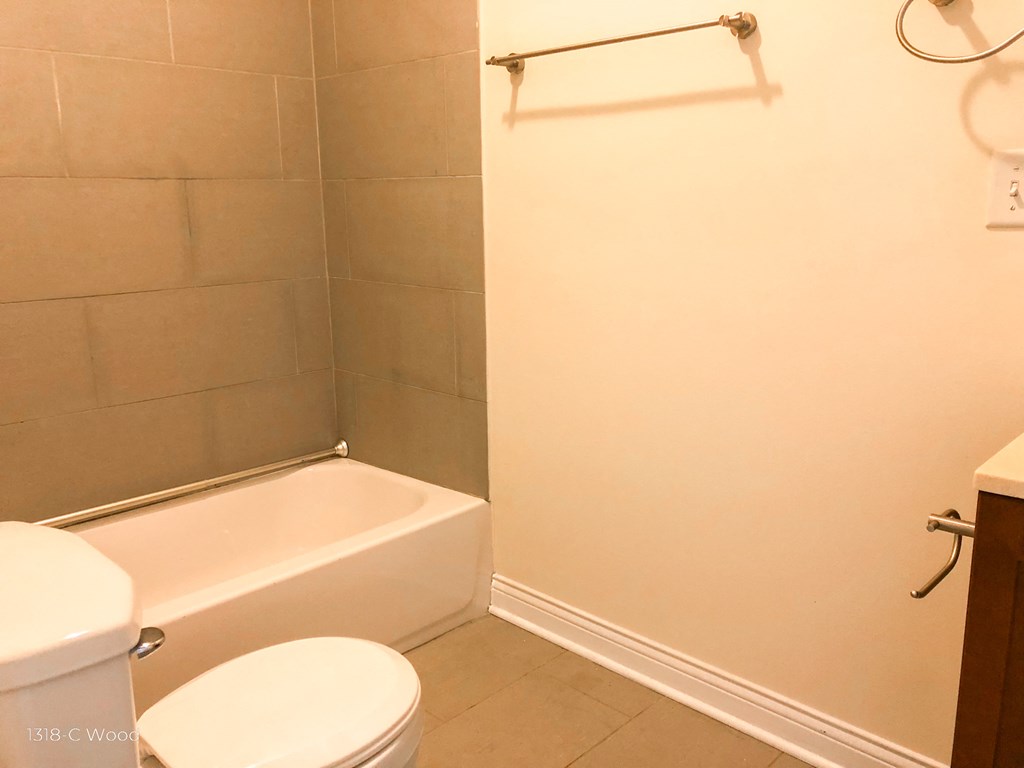 a small bathroom with a toilet and a bath tub