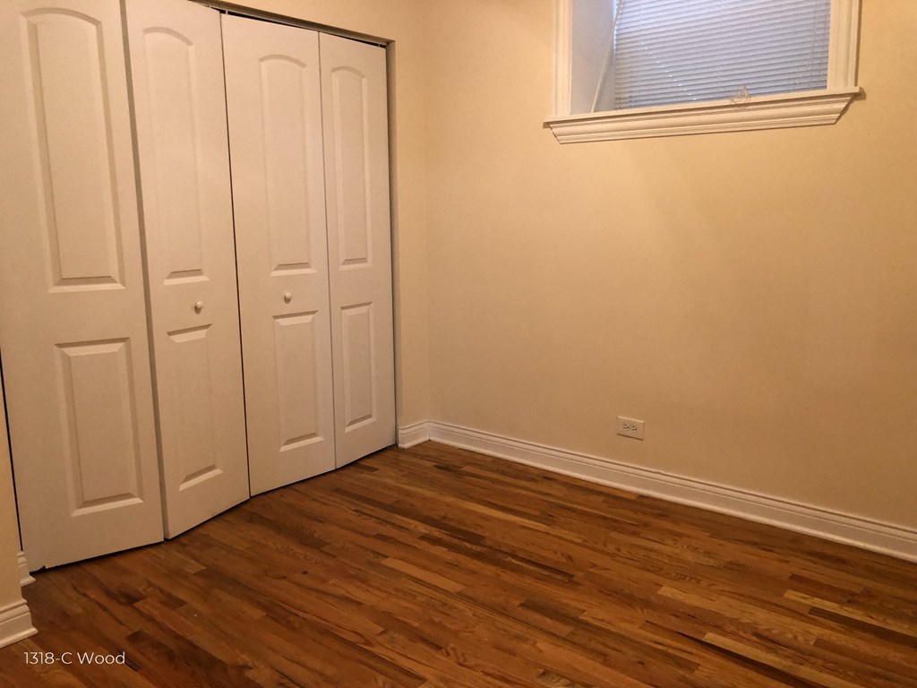 the bedroom has two closets and a window