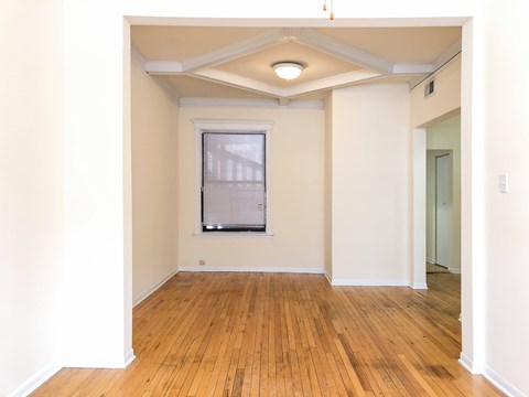 A room with wooden floors and a window.