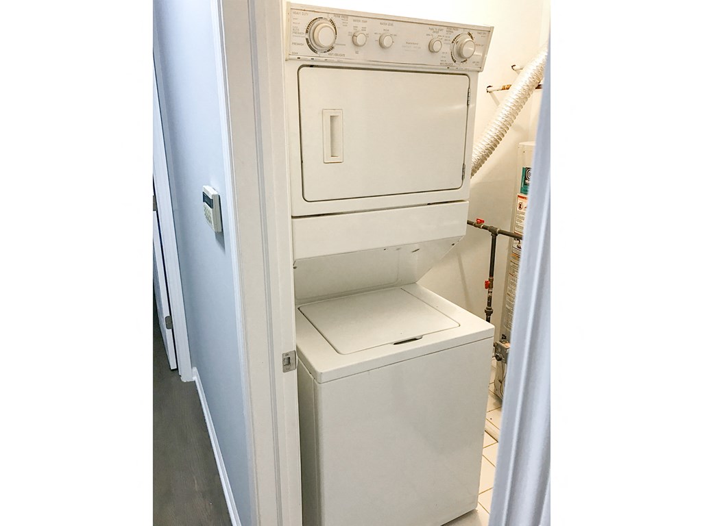 an empty laundry room with a washer and dryer