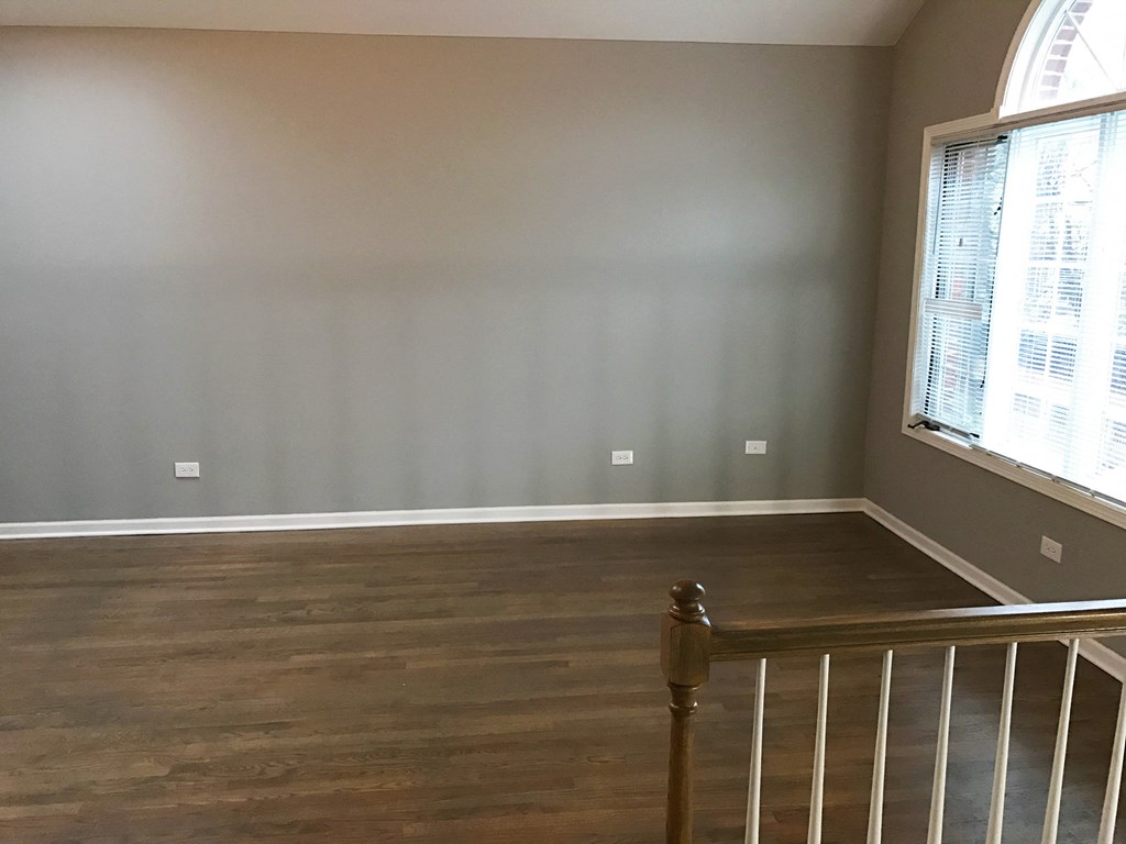 the view from the top of the stairs looking into the living room