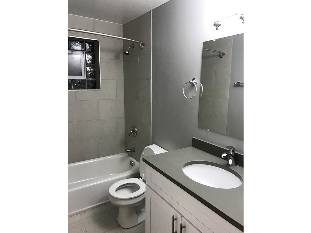 an image of a bathroom with a toilet sink and tub