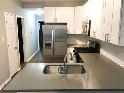 a kitchen with stainless steel counter tops and a sink