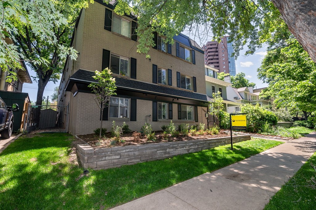 the front of a house with a sidewalk in front of it