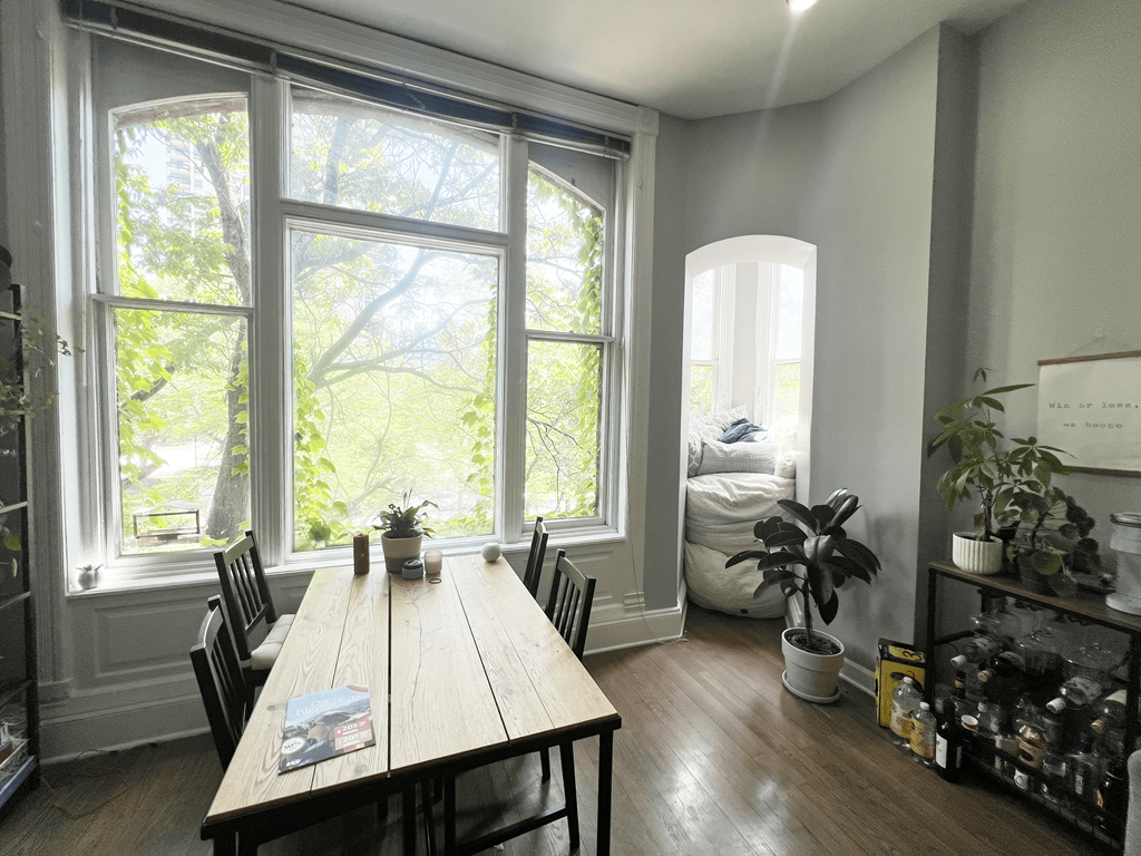 a dining room with a wooden table and a large window