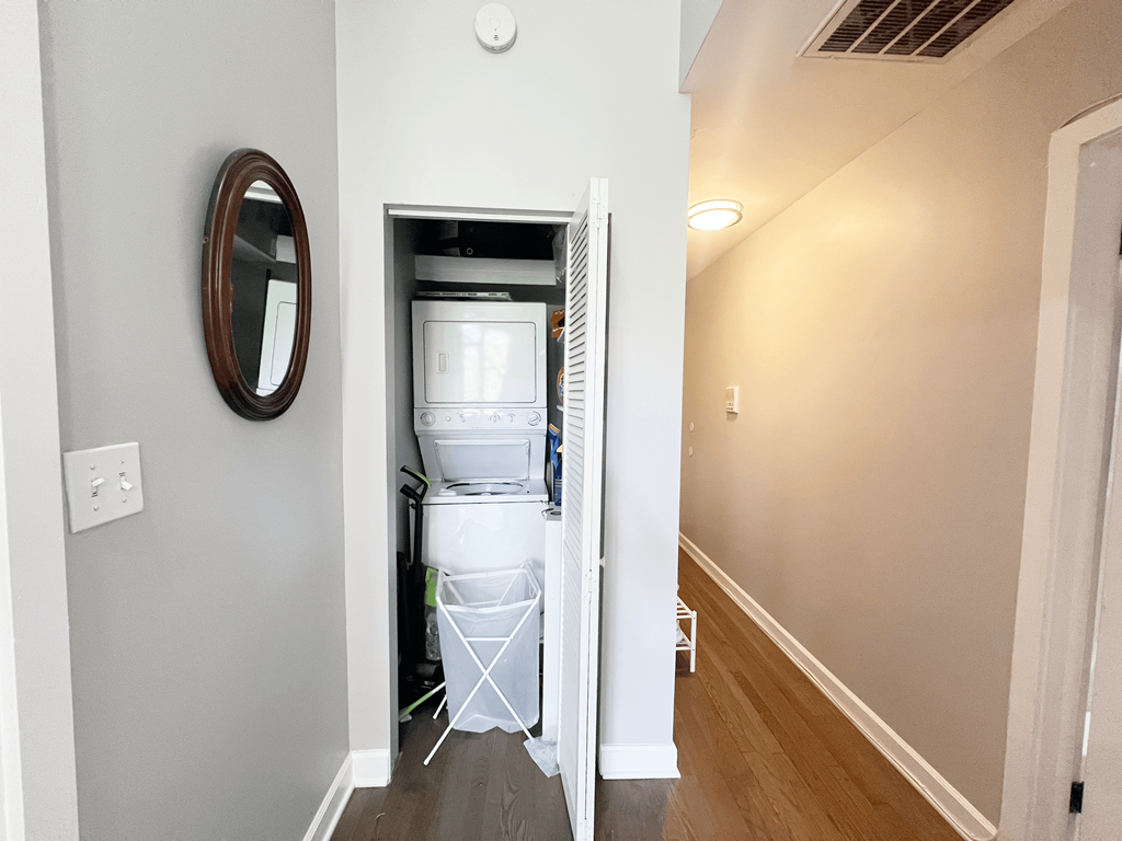 a laundry room with a washer and dryer and a door to a closet