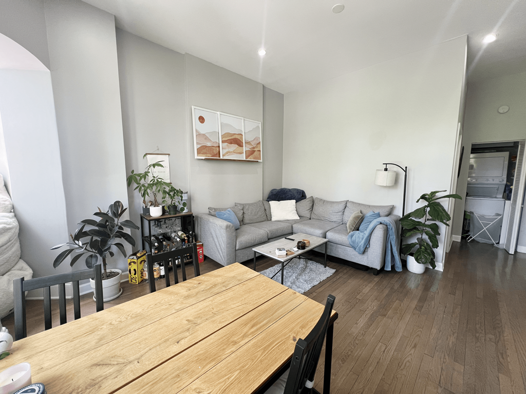 a living room and dining room with a wooden table