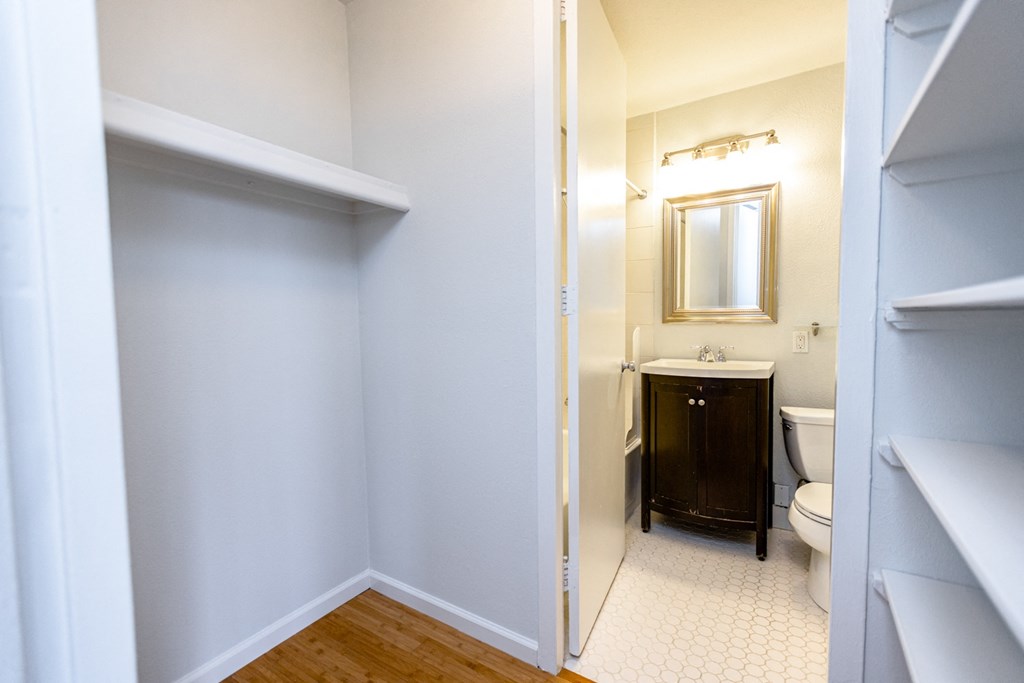 a bathroom with a toilet and a sink and a mirror