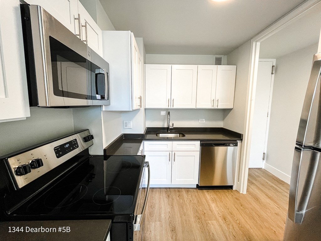 a kitchen with stainless steel appliances and white cabinets