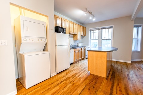 A kitchen with a white fridge and a white oven.
