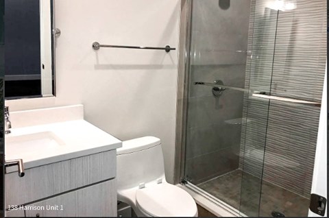 a bathroom with a toilet sink and shower