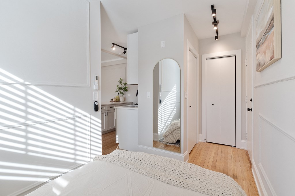 a bedroom with a bed and a mirror