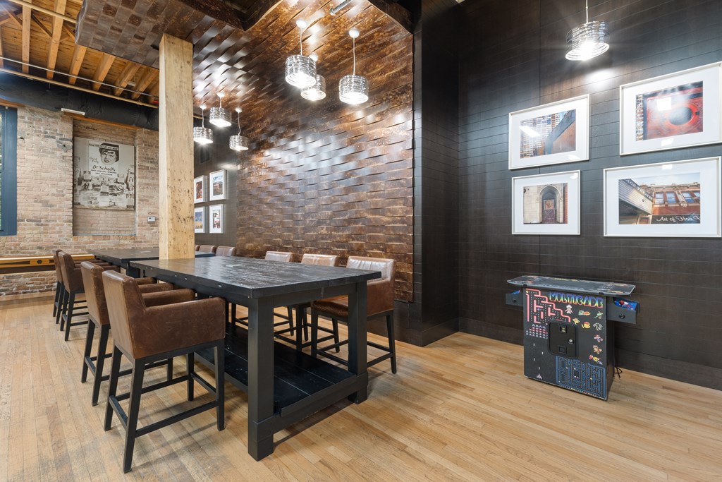 a dining room with a long table and chairs and a wooden floor
