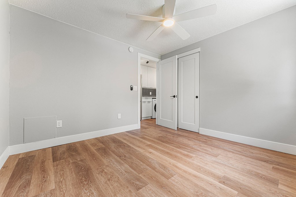 a living room with hardwood floors and grey walls