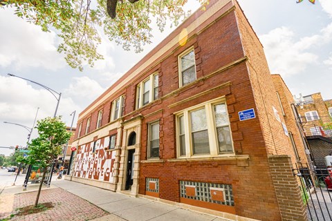 A red brick building with a blue plaque on the front.