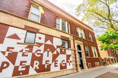 A building with a mural that reads "Fech Perfeck".