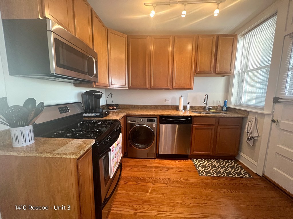 a kitchen with wooden cabinets and a stove and a dishwasher
