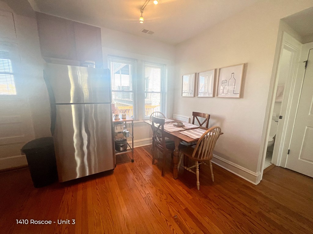 a dining room with a table and a refrigerator