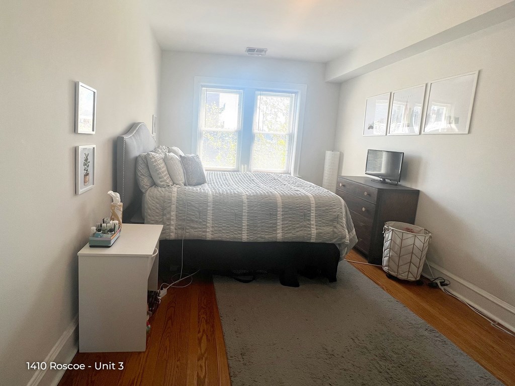 a bedroom with a large bed and a window