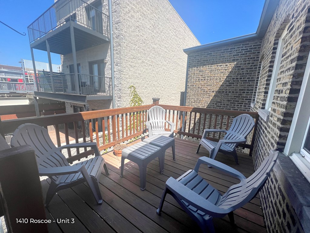 a view of the balcony with chairs and a table