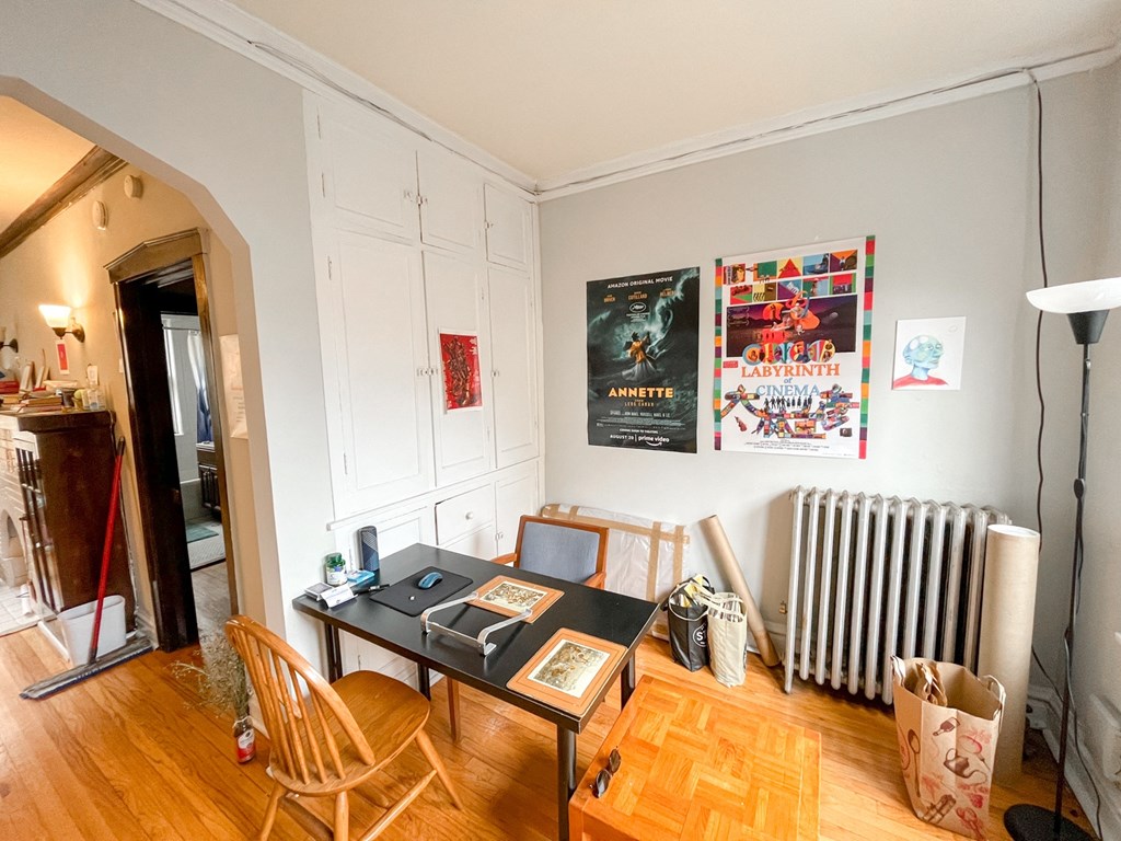 a home office with a desk and a radiator