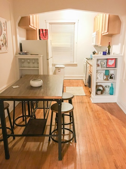 A kitchen with a table and chairs in the middle of the room.