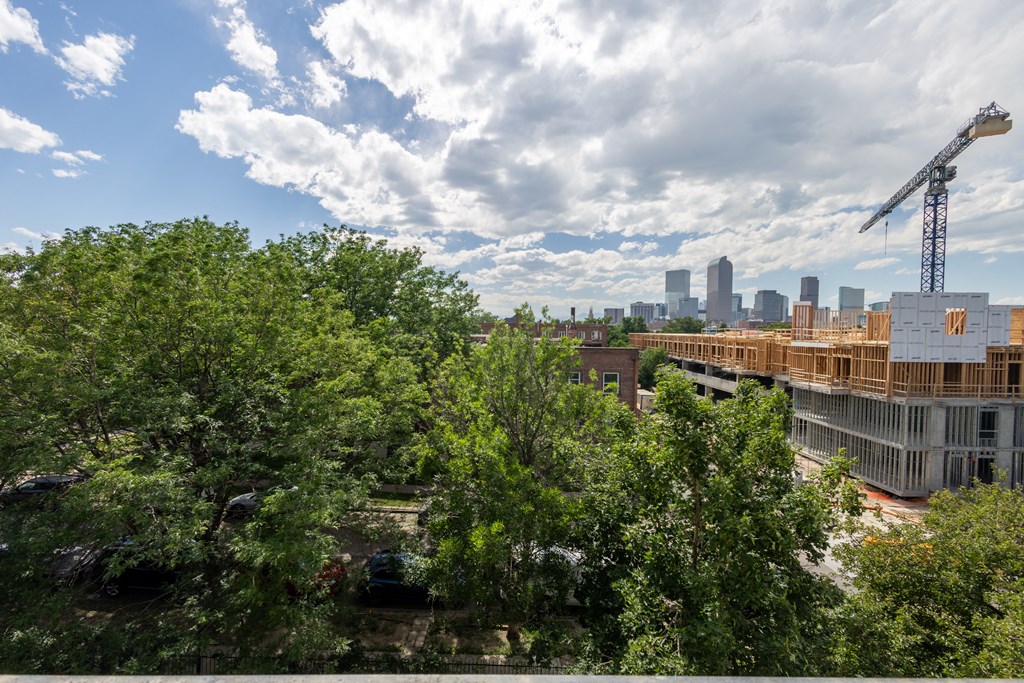 the building is under construction with the skyline in the background
