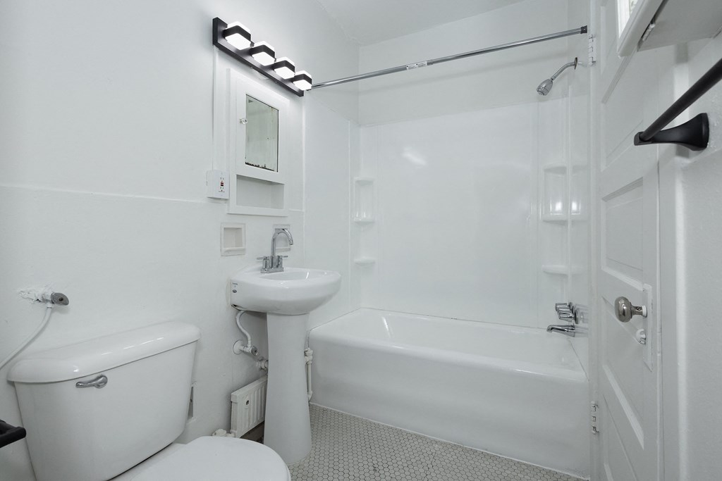 a bathroom with a sink toilet and a bath tub