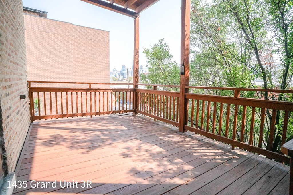a deck with a view of the city and trees