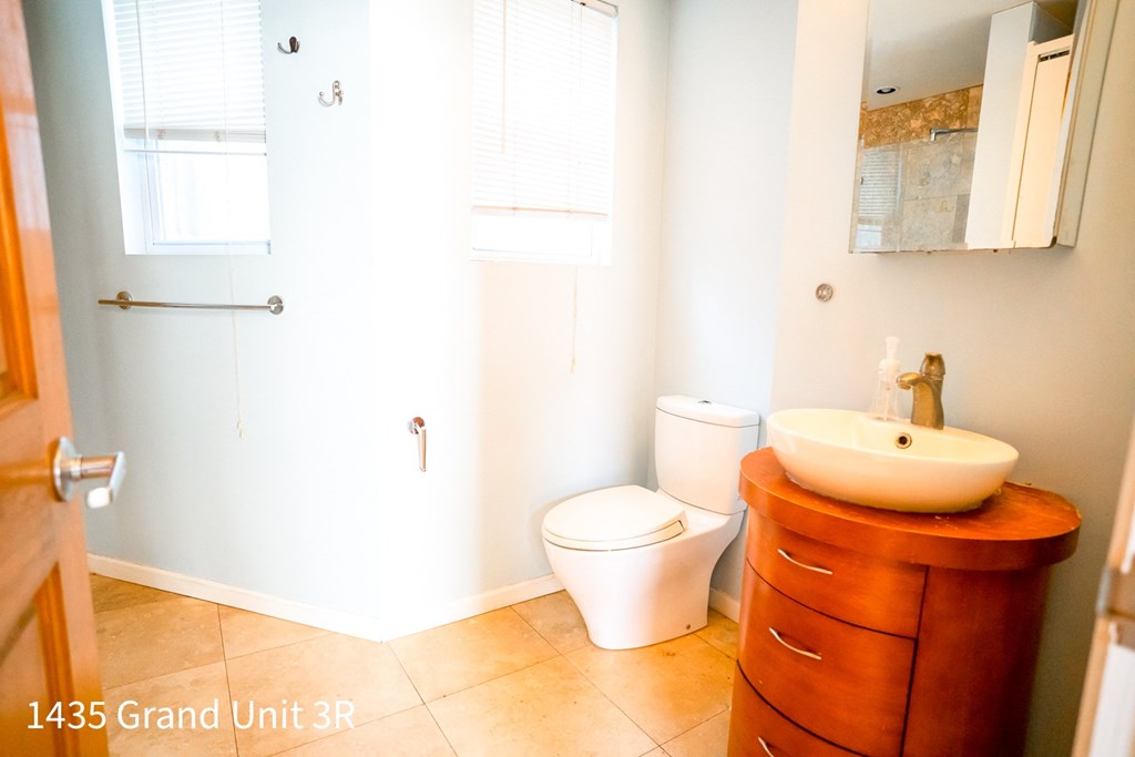 a bathroom with a toilet and a vanity with a sink