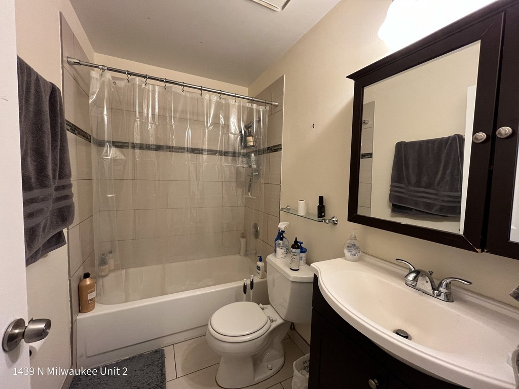 a bathroom with a sink and a toilet and a shower