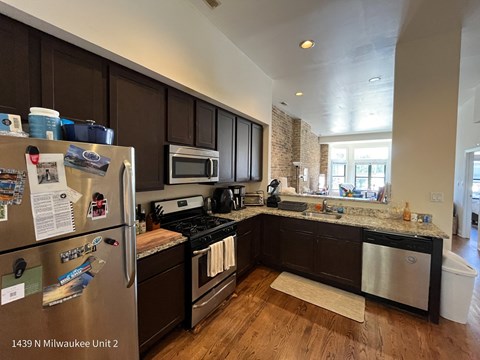 a kitchen with stainless steel appliances and black cabinets