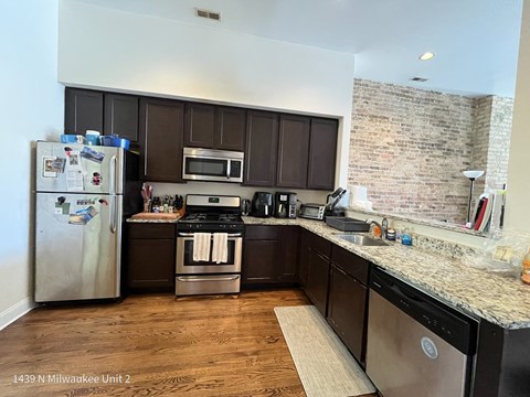 a kitchen with stainless steel appliances and granite counter tops