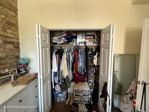 a closet with a lot of clothes in it