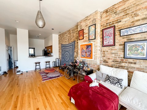 A living room with a red couch and a white couch.