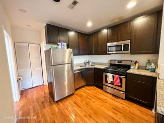 a kitchen with stainless steel appliances and a hardwood floor