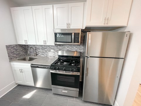 A kitchen with a stove, oven, and refrigerator.